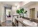 Bright bathroom with double sinks, modern fixtures, decorative plants, and elegant mirrors, creating a refreshing space at 1612 Ellesmere Ave, Haines City, FL 33844