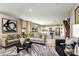 Bright living room featuring stylish gray sofas, bold geometric patterns, and an open layout with a glimpse of the kitchen at 1612 Ellesmere Ave, Haines City, FL 33844