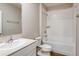 Bright bathroom features a single sink vanity, toilet, and shower with a tub at 4063 Gardenia Ave, Lake Hamilton, FL 33851
