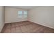 Neutral bedroom with carpet, baseboards, and two windows with blinds at 4063 Gardenia Ave, Lake Hamilton, FL 33851
