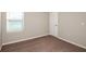 Neutral bedroom features a window with blinds and cozy brown carpeting at 4063 Gardenia Ave, Lake Hamilton, FL 33851