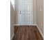 Entryway with wood-look flooring leads to a white front door with sidelight at 4063 Gardenia Ave, Lake Hamilton, FL 33851