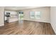 Open-concept living room featuring luxury vinyl floors and sliding glass doors to the backyard at 4063 Gardenia Ave, Lake Hamilton, FL 33851