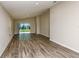 Spacious living room with wood floors and sliding glass doors to the backyard at 4071 Gardenia Ave, Lake Hamilton, FL 33851