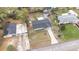 This aerial view shows the home's roof, driveway, and landscaping, with a glimpse of the neighborhood at 122 2Nd Jpv St, Winter Haven, FL 33880