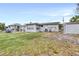 A backyard featuring a patio, storage shed, and well-maintained lawn at 122 2Nd Jpv St, Winter Haven, FL 33880