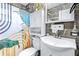 Stylish bathroom with decorative shower curtain, gray-veined tile, a white vanity, and a modern toilet at 122 2Nd Jpv St, Winter Haven, FL 33880