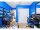 Blue bedroom with a bunk bed, carpet, and a desk setup for gaming at 122 2Nd Jpv St, Winter Haven, FL 33880
