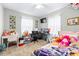 Bright bedroom featuring a desk, TV, and carpeted flooring at 122 2Nd Jpv St, Winter Haven, FL 33880