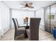 Cozy dining room featuring a glass-top table, covered chairs and natural light at 122 2Nd Jpv St, Winter Haven, FL 33880