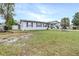 Single-story home featuring a spacious lawn and a convenient carport at 122 2Nd Jpv St, Winter Haven, FL 33880