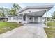 Single-story house showcasing a wide driveway and covered carport area at 122 2Nd Jpv St, Winter Haven, FL 33880