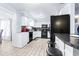Bright kitchen with white cabinets, black appliances, and an efficient layout at 122 2Nd Jpv St, Winter Haven, FL 33880