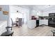Kitchen showcasing an open layout with adjacent dining area, white cabinets and modern appliances at 122 2Nd Jpv St, Winter Haven, FL 33880