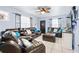 Comfortable living room featuring tile floors, a ceiling fan, and abundant seating at 122 2Nd Jpv St, Winter Haven, FL 33880