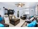 Inviting living room with comfortable seating, a ceiling fan, and a view into the kitchen at 122 2Nd Jpv St, Winter Haven, FL 33880
