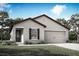 Charming single-story home with a well-manicured lawn, two-car garage, and covered porch at 1637 Nantucket Way, Winter Haven, FL 33884