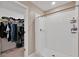 Bathroom showcasing tiled shower, shower curtain, and a glimpse into the closet space at 1773 Yellow Trl, Lakeland, FL 33801