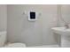 Half bathroom with a toilet, pedestal sink, modern faucet, and decorative mirror at 1773 Yellow Trl, Lakeland, FL 33801