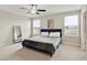 A well-lit bedroom featuring a plush bed, large windows, and neutral tones at 1773 Yellow Trl, Lakeland, FL 33801