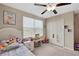 Bedroom with a ceiling fan, window, closet, and playful decor, creating a cozy retreat at 1773 Yellow Trl, Lakeland, FL 33801