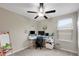 Functional bedroom space with a ceiling fan, desk setup, and natural light from a nearby window at 1773 Yellow Trl, Lakeland, FL 33801