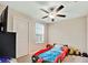 Themed bedroom, featuring a car bed, ceiling fan, window, and door at 1773 Yellow Trl, Lakeland, FL 33801