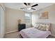 Cozy bedroom with a ceiling fan, a framed art piece, and natural light from a nearby window at 1773 Yellow Trl, Lakeland, FL 33801