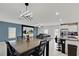 Open-concept dining area with a stylish chandelier, table, and view to the living room and kitchen at 1773 Yellow Trl, Lakeland, FL 33801