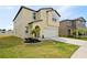 Two-story home with a two-car garage, lawn, and landscaping at 1773 Yellow Trl, Lakeland, FL 33801