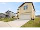 Two-story home featuring a two car garage, manicured lawn and driveway at 1773 Yellow Trl, Lakeland, FL 33801