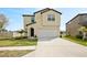 Two-story home featuring a manicured lawn, fresh landscaping, and a two-car garage at 1773 Yellow Trl, Lakeland, FL 33801