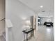 View of tiled foyer, staircase and living room with a modern decorative table at 1773 Yellow Trl, Lakeland, FL 33801