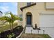 Front door featuring fresh landscaping, lighting, and an arched entry at 1773 Yellow Trl, Lakeland, FL 33801