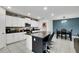 A spacious kitchen with white cabinets, stainless appliances, an island and an adjacent dining area at 1773 Yellow Trl, Lakeland, FL 33801