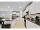 A bright and open kitchen with white cabinets, granite countertops, and stainless steel appliances at 1773 Yellow Trl, Lakeland, FL 33801