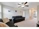 An upstairs Gathering room with neutral walls and carpet, ceiling fan and comfortable seating at 1773 Yellow Trl, Lakeland, FL 33801