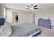 Spacious bedroom featuring a ceiling fan, dresser, and walk-in closet, offering comfort and ample storage at 1773 Yellow Trl, Lakeland, FL 33801