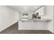 Beautiful, bright kitchen featuring stainless steel appliances, granite countertops, and wood-look flooring at 1786 White Elephant Loop, Winter Haven, FL 33884
