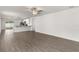 Open-concept living room with modern wood-look flooring and seamless transition to the kitchen at 1786 White Elephant Loop, Winter Haven, FL 33884