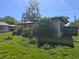 View of the exterior of the home with overgrown foliage at 1122 E Edgewood Dr, Lakeland, FL 33803