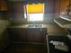 Kitchen featuring laminate countertops, wood cabinets, and a double basin sink at 1122 E Edgewood Dr, Lakeland, FL 33803