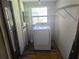 Laundry room featuring a white dryer, a window, and shelving at 1122 E Edgewood Dr, Lakeland, FL 33803