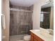 Bathroom featuring a walk-in shower with a grab bar and modern tilework at 15387 Avenue Of The Arbors, Winter Garden, FL 34787