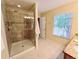 This bathroom features a walk-in shower with glass door and a view of the exterior at 15387 Avenue Of The Arbors, Winter Garden, FL 34787