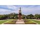 Beautiful clock tower on a sunny day, surrounded by trees and green grass at 15387 Avenue Of The Arbors, Winter Garden, FL 34787