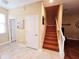 Inviting foyer features staircase with wood steps and white banister, leading to the upper level at 15387 Avenue Of The Arbors, Winter Garden, FL 34787