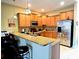 Well-equipped kitchen featuring granite countertops, modern appliances, and ample storage at 15387 Avenue Of The Arbors, Winter Garden, FL 34787