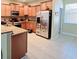 Bright kitchen with stainless steel appliances, granite counters, and breakfast bar seating at 15387 Avenue Of The Arbors, Winter Garden, FL 34787