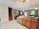 Open-concept kitchen flowing into the living area, featuring stainless steel appliances at 15387 Avenue Of The Arbors, Winter Garden, FL 34787